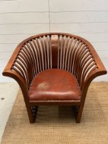A teak slatted curved round armchair in the style of Hoffman