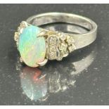 An opal and diamond ring on 14k white gold, approximate total weight 5.5g. Size L
