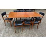 An extending teak dining table by Vanson along with the Vanson for Heals eight chairs whit black