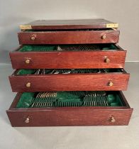 A canteen of cutlery, with ten place settings and some spares spread over a four drawer canteen with