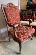 A French Louis style armchair, carved oak frame and upholstered with stud detail