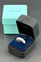 Four row diamond eternity ring mounted in platinum. Signed Tiffany 950. Total diamond weight