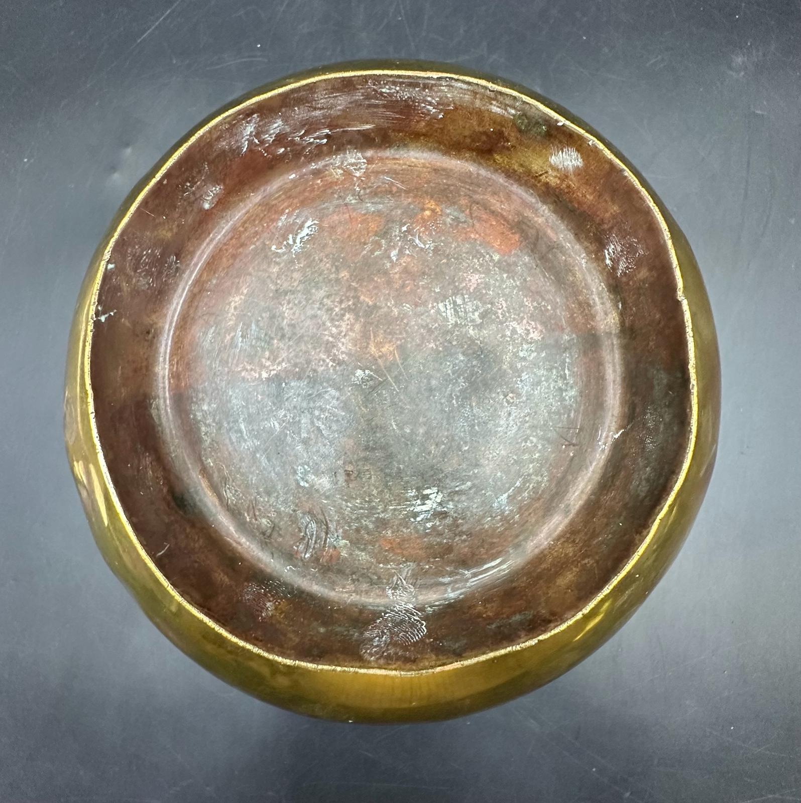 An antique brass bowl with four floral decorations, 21.5cm across and 12cm H - Image 6 of 6