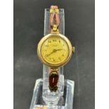 A J W Benson of London ladies wristwatch in 9ct gold on leather bracelet.