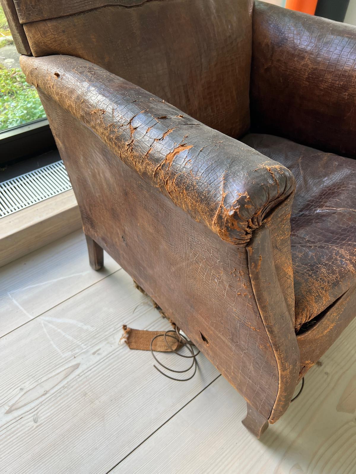 An antique leather club chair in distressed manner with scrolling arms (H95cm W71cm D31cm SH43cm) - Image 2 of 5