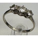 A three stone diamond ring on 18ct white gold and platinum set Size N