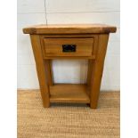A light oak side table with single drawer and shelf under (H76cm W60cm D32cm)
