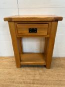 A light oak side table with single drawer and shelf under (H76cm W60cm D32cm)