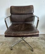 A Vitra Eames soft pad chair with brown leather and chrome open arms