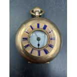 A 14ct gold cased ladies fob watch of half hunter style, dial to outer case with Roman numeral