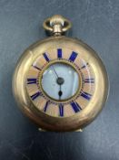 A 14ct gold cased ladies fob watch of half hunter style, dial to outer case with Roman numeral