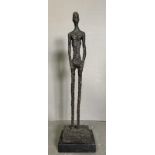 A bronze sculpture of The Tall Man in a marble plinth and signed Giacometti to base H47cm