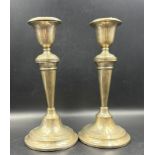 A pair of silver candlesticks, hallmarked for Birmingham 1938.