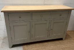 A grey painted three drawer and three cupboard sideboard (H83cm W139cm D42cm)