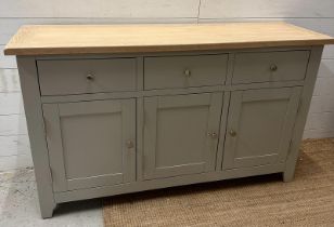 A grey painted three drawer and three cupboard sideboard (H83cm W139cm D42cm)