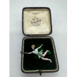 A silver and enamel tennis player brooch (5.5cm)