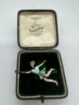 A silver and enamel tennis player brooch (5.5cm)