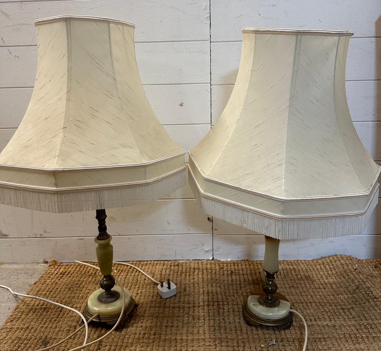 A pair of brass base table lamps