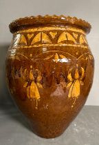 A brown studio pottery planter with crimped rim and floral motif. Height 43