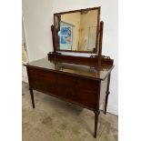 An Art Deco style mahogany dressing table, two short drawers, one long drawer over and a framed