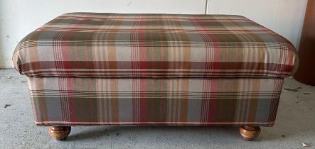 A contemporary ottoman/footstool on bun feet upholstered in red and green check (H45cm W100cm