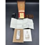 A Dunhill white metal lighter in original box with original paperwork, cards etc.