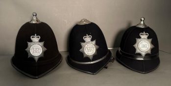 Three vintage police helmets. Humberside, West Midlands and Devon and Cornwall forces