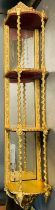 A gilt three shelf wall hanging unit in the rococo style with barley twist supports and mirrored