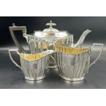 A three piece silver tea service by Lee & Wigfull with a semi fluted design hallmarked for Sheffield