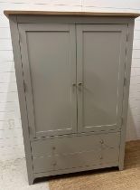 A grey painted cupboard, two doors, three shelves with two long drawers under (H175cm W114cm D42cm)