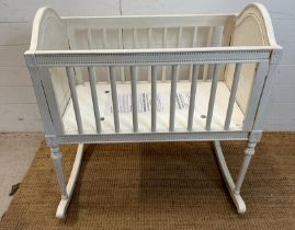 A white painted baby's crib on rockers with studded details (H86cm W85cm D68cm)