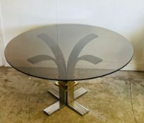 A vintage circular glass dining table on a chrome base and brass by Banci and Fireaze (H72cm