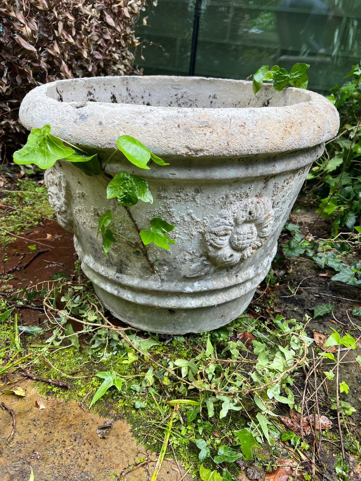 A pair of composite stone planters with rose crowns to sides (H43cm Dia56cm)