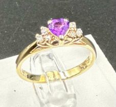 A 14ct gold amethyst and diamond shoulders with a heart shaped central stone on a 14ct yellow gold
