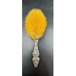 An ornate classical themed silver backed dressing table brush by Levi & Salaman, Birmingham 1900