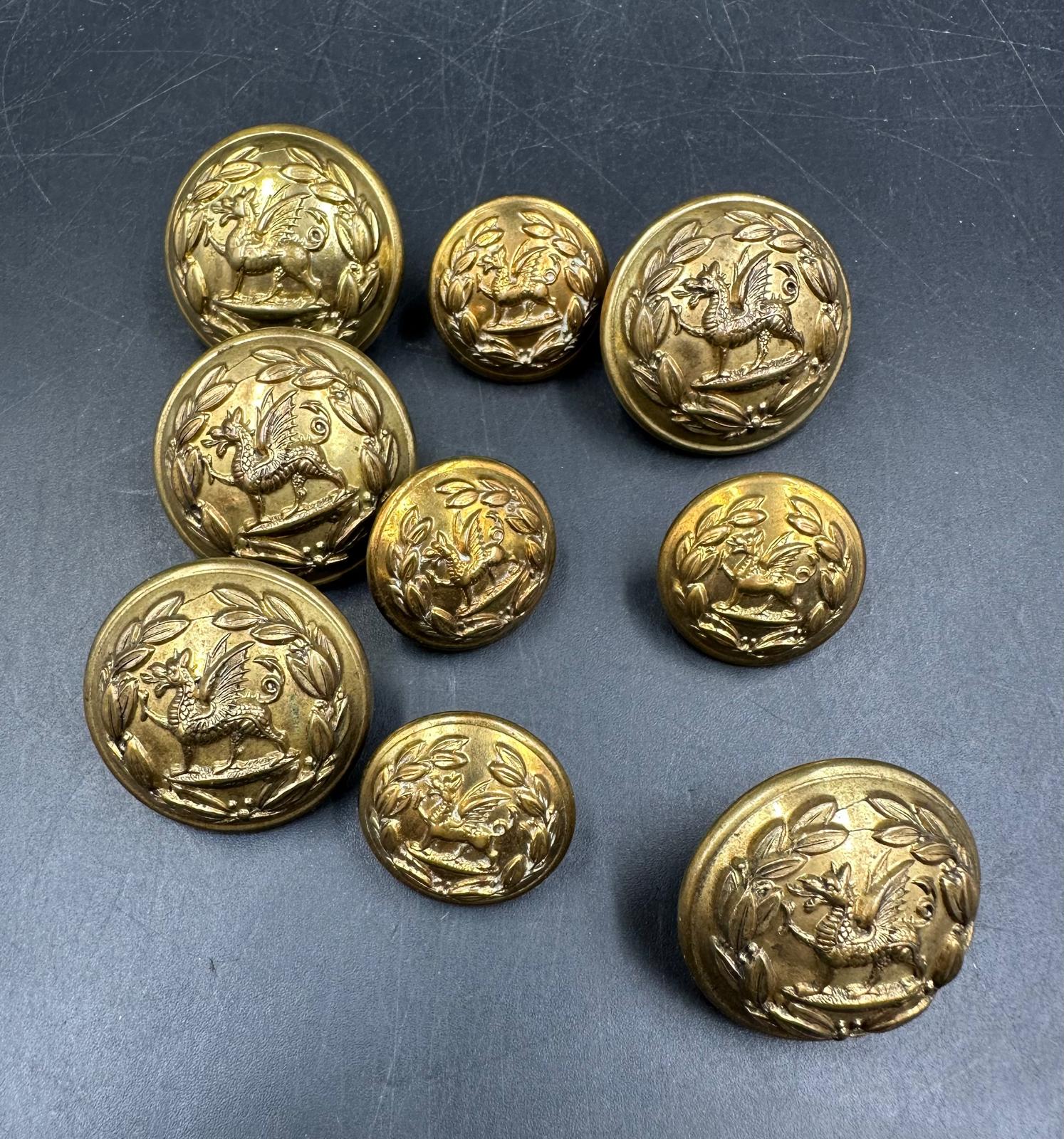 A small selection of brass military buttons.