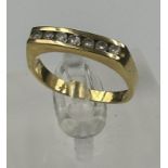An 18ct gold ring with seven small diamonds and an approximate weight of 4.3g. Size N