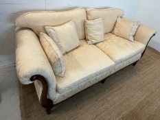 A large two seater sofa with scrolling wooden frame by Medallion (H83cm W197cm D94cm SH53cm)