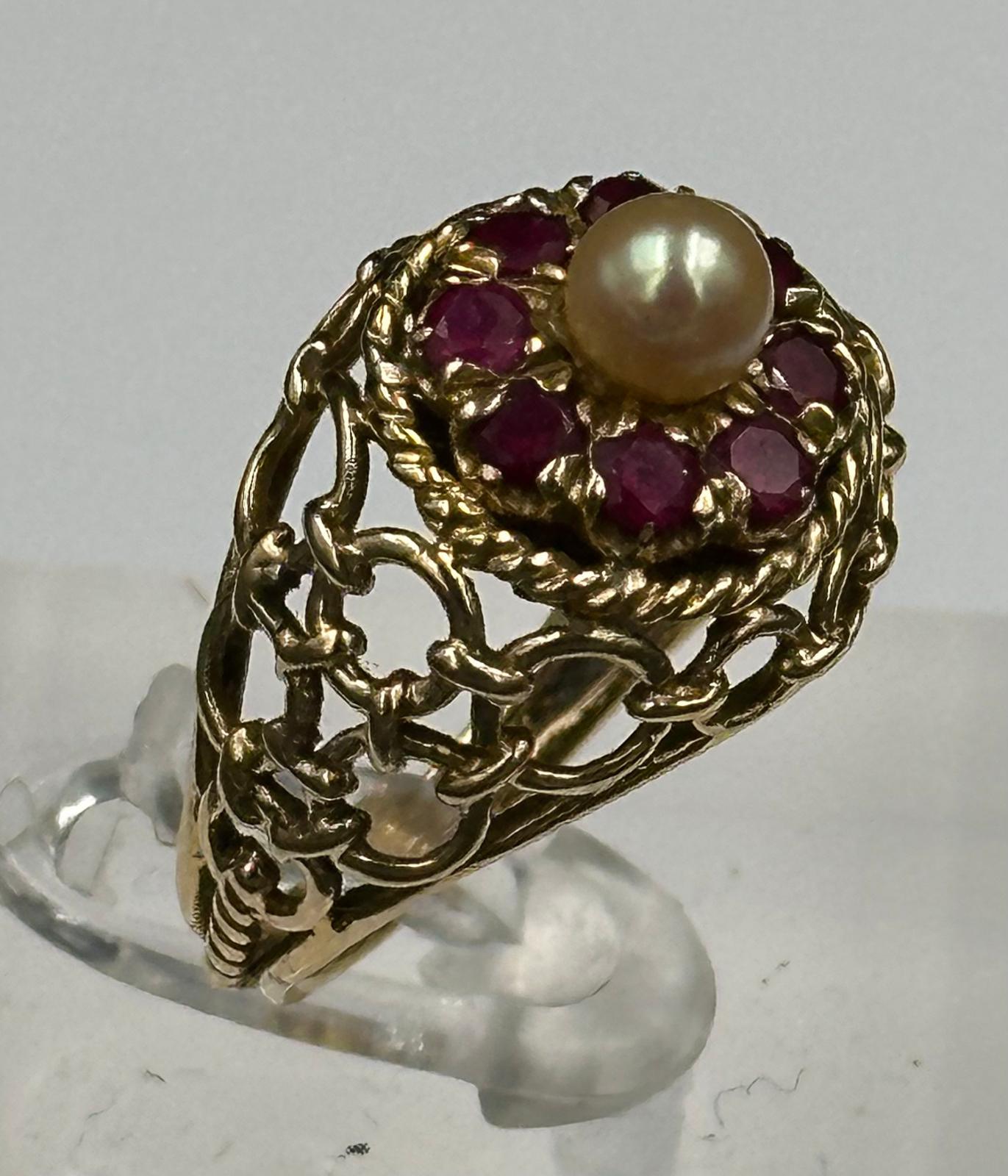 An Arabian gold cocktail ring with ruby and central pearl, approximate total weight 6.7g.