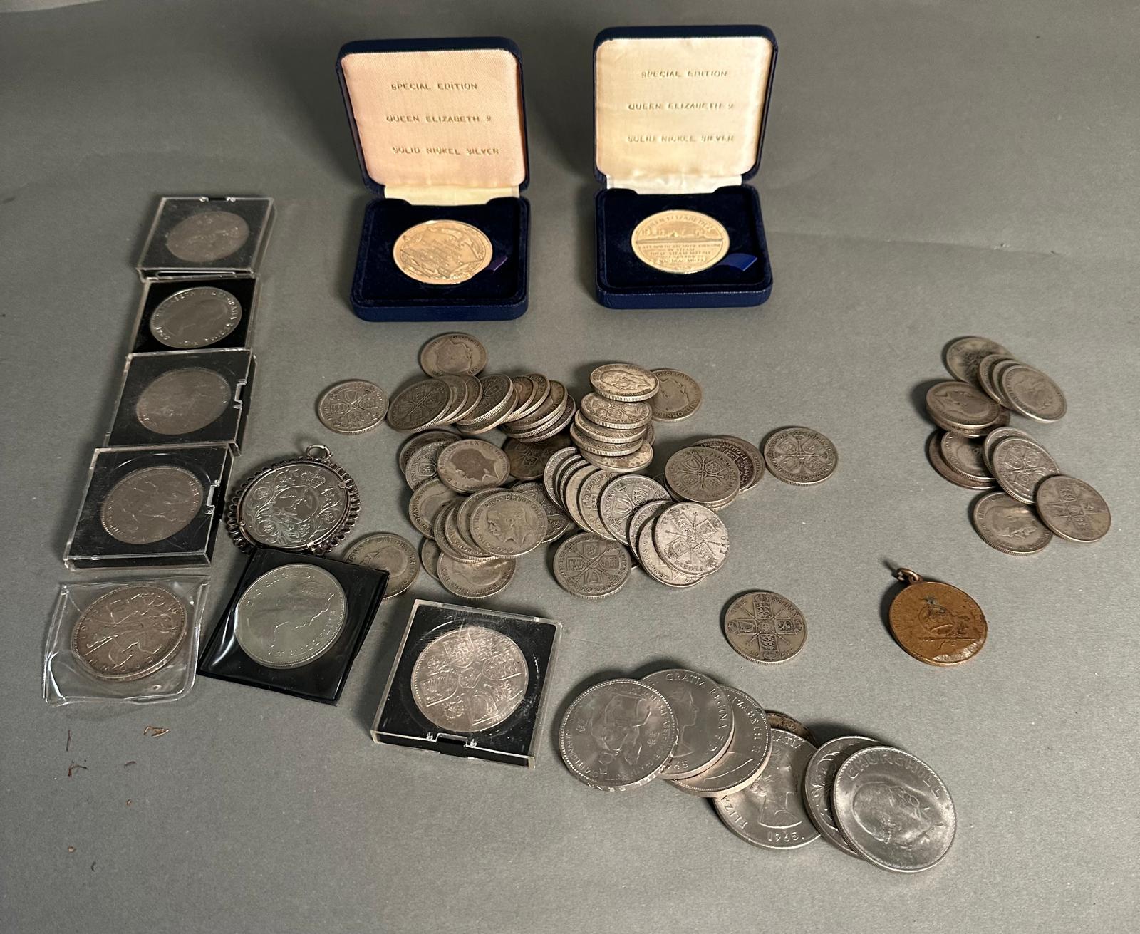 A selection of Great British coins to include Crowns, Florins and several medallions.