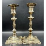 A pair of ornate silverplated candlesticks.