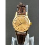 Gold Omega Ladymatic wristwatch on a brown leather strap. 26mm case. Plexi glass. Swiss Gold