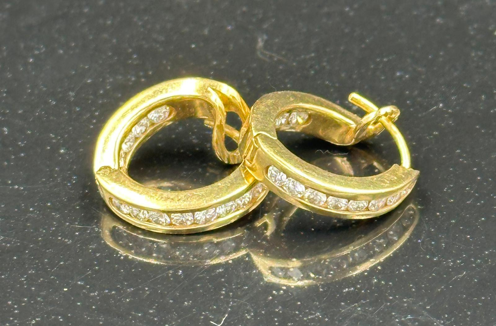 A Gold diamond hoop earrings mounted in 18ct gold. Signed T&Co. Total diamond weight approximately