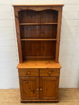 A pine dresser with open shelves upon a cupboard base (H180cmW80cm D43cm) Condition Report general