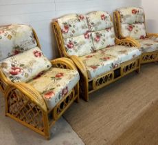 A bamboo three piece conservatory suite comprising of a two seater sofa and two arm chairs,