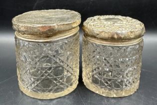 Two hallmarked silver lidded cut glass vanity jars