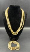 A three strand pearl necklace and three strand pearl bracelet on floral designed 9ct gold fastener