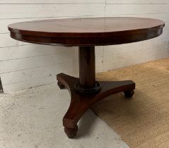 A Georgian style mahogany centre table on castors. Height 73 diameter 110