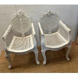 A pair of French painted Bergère arm chairs