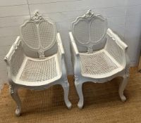 A pair of French painted Bergère arm chairs